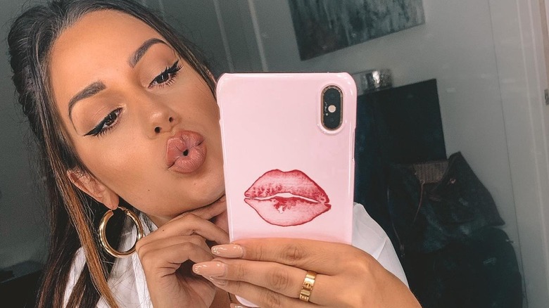 Woman taking selfie with kissy lips