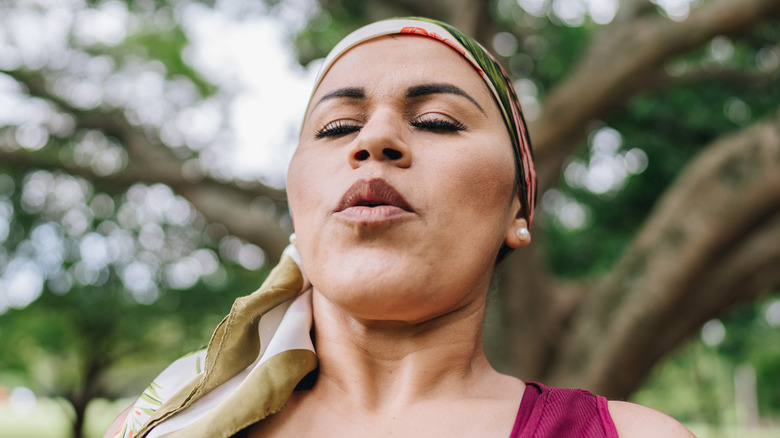 Woman doing breathing exercises outside