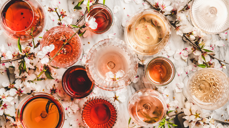 various types of wine in glasses on top of table