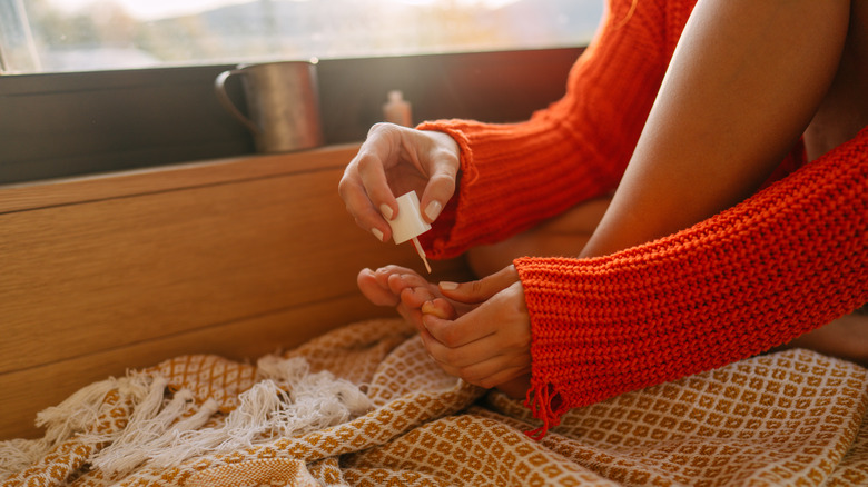 Woman painting her toenails