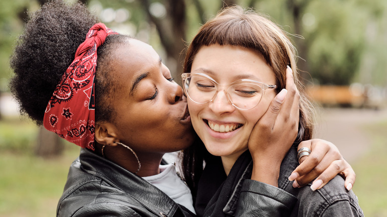 woman kissing partner on cheek