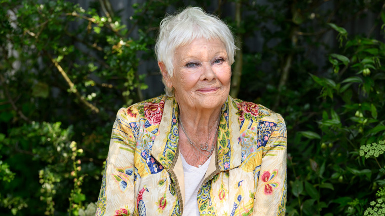 Dame Judi Dench sitting in a garden