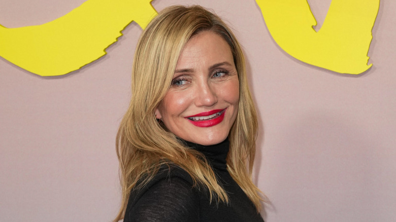 Cameron Diaz wearing a black dress posing for a photo at Apple's 