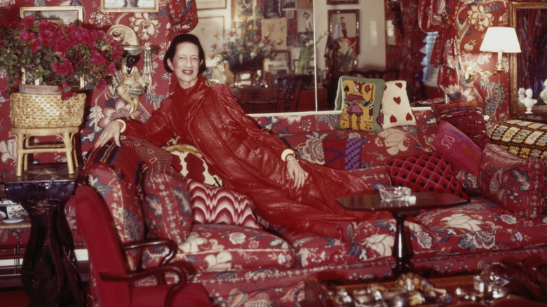 Diana Vreeland in a red dress posing in her red-themed apartment dubbed "Garden in Hell"