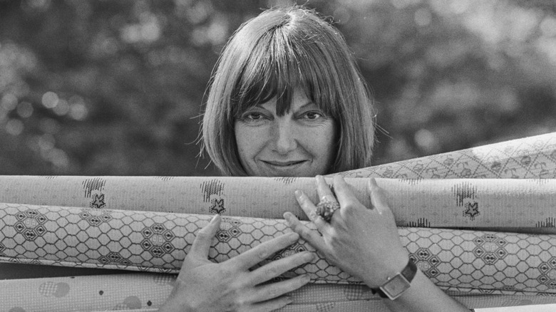Mary Quant holding bolts of fabric.