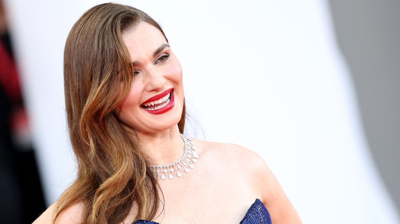Rachel Weisz wearing laughing while wearing a diamond necklace