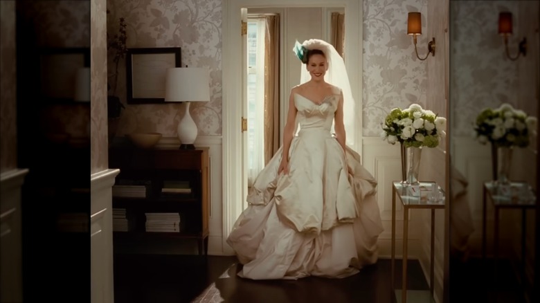 Sarah Jessica Parker as Carrie Bradshaw wearing a voluminous draped wedding dress and veil.