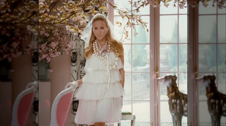 Sarah Jessica Parker as Carrie Bradshaw wearing a tulle tiered wedding dress and a mini veil.