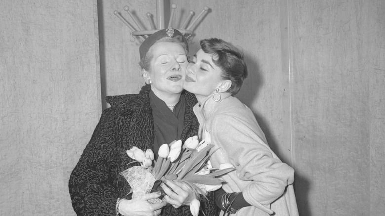 Audrey Hepburn and her mother Ella van Heemstra holding flowers in 1953