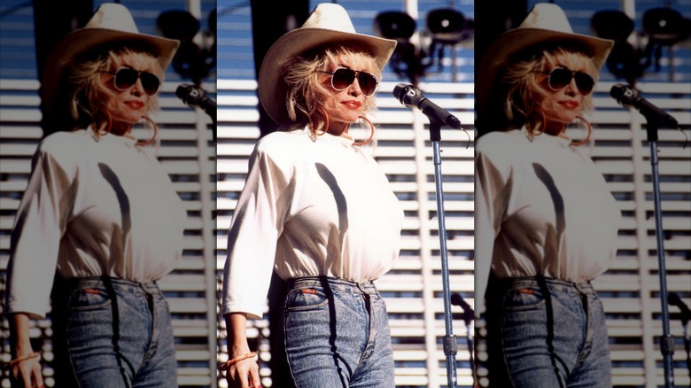 Dolly Parton wore a white top, matching cowgirl hat, and jeans