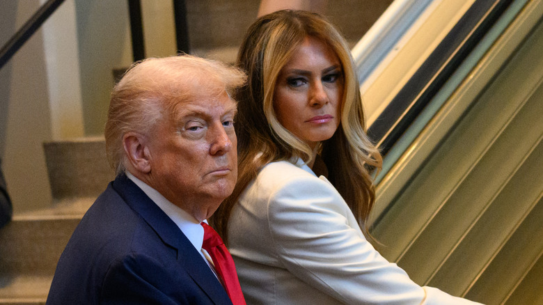 Donald and Melania steppinng on an escalator