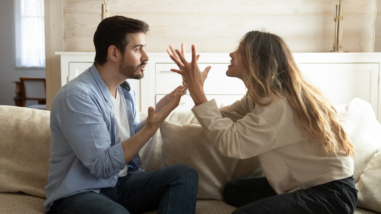 couple arguing on the couch
