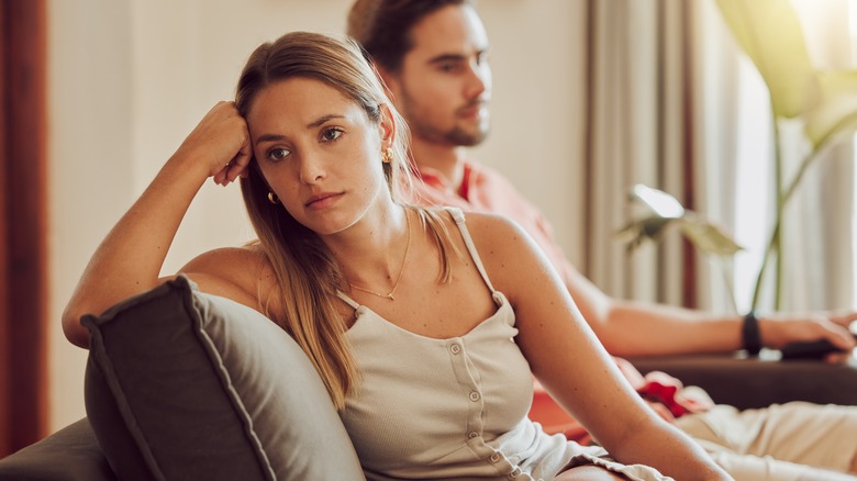 Woman concerned on a couch