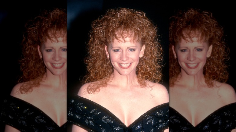 Reba McEntire in a black off-the-shoulder dress with defined curly hair at the 1992 People's Choice Awards.