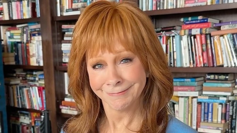 Reba McEntire with poorly done makeup smiling during a meet at Reba's place