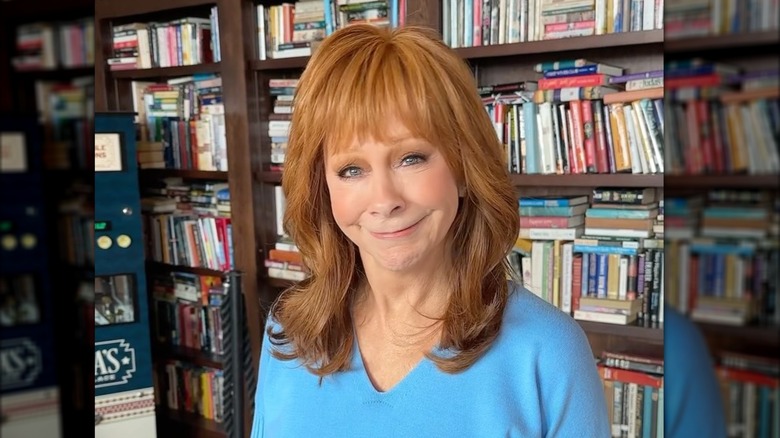 Reba McEntire with poorly done makeup smiling during a meet at Reba's place