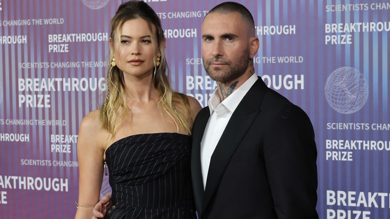 Behati Prinsloo and Adam Levine wearing black