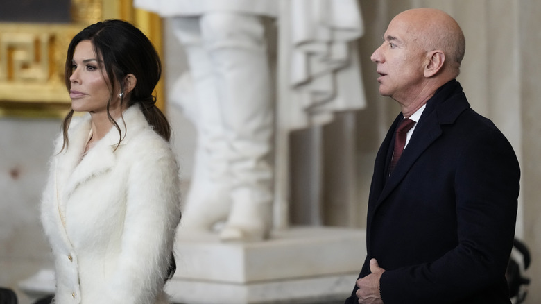 Lauren Sanchez walking ahead of Jeff Bezos
