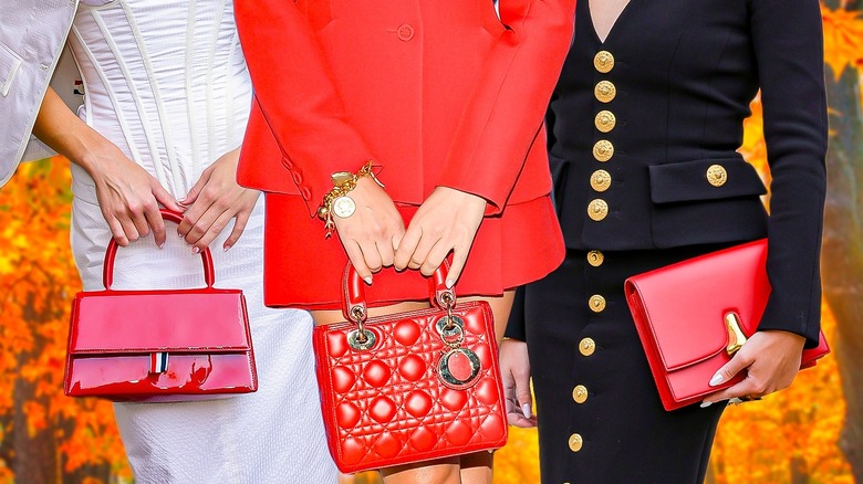 women holding red bags
