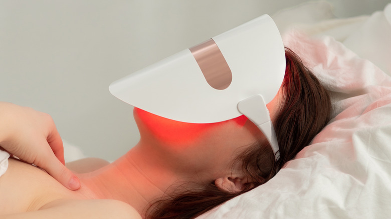 woman wearing red light mask