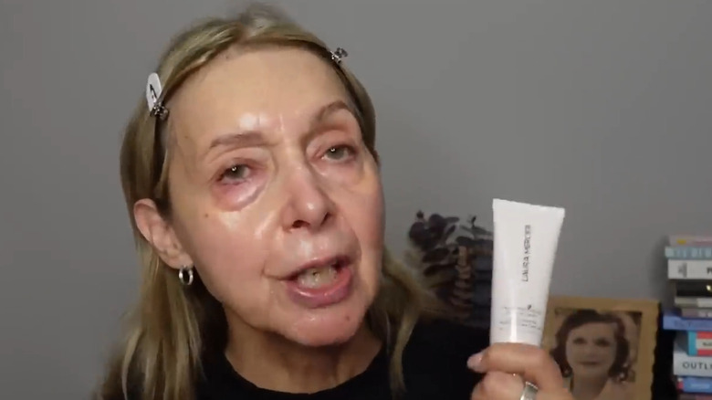 Woman holding Laura Mercier tinted moisturizer