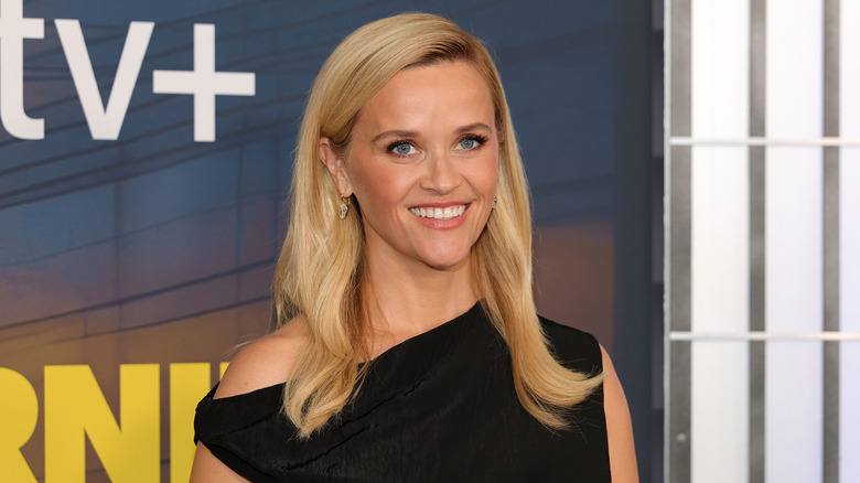 Reese Witherspoon posing at "The Morning Show" season 4 premiere in a black dress.