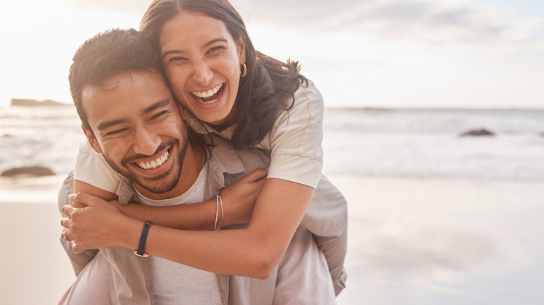 A couple smiling on the beach