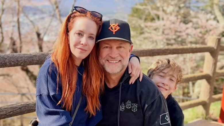 Amy Davidson poses with her husband and son in nature