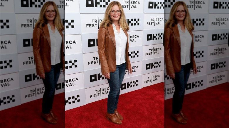 Elizabeth Shue wearing jeans with a white top and a brown jacket with matching shoes at the Good Half Premierre