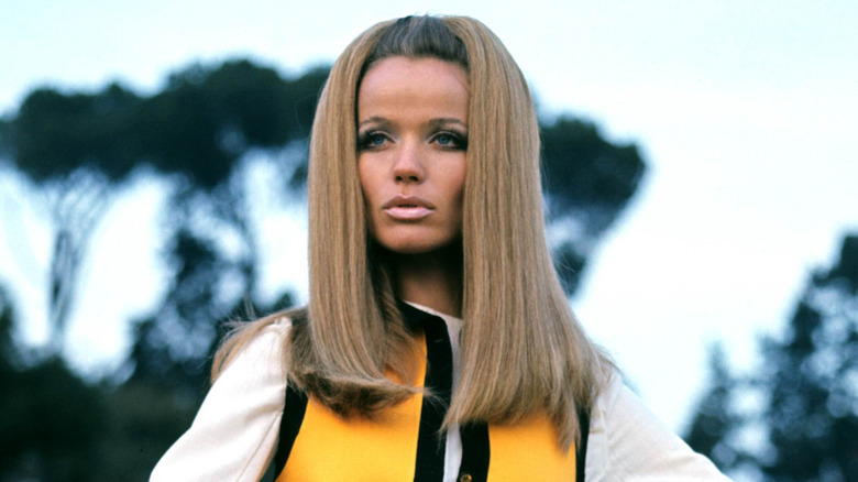 Veruschka posing in a white top and yellow vest