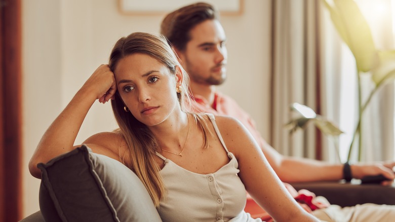 Couple having disagreement on couch