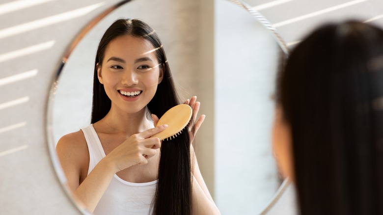 woman brushing long hair 