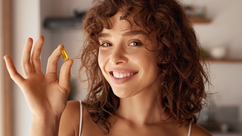 Woman holding pill