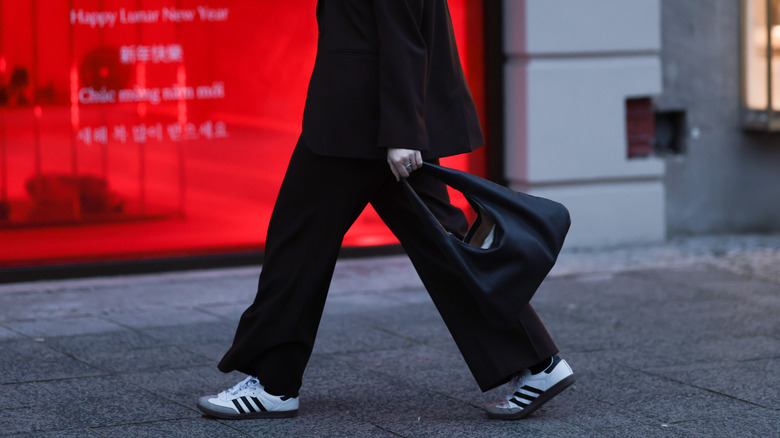 Woman wearing retro sneakers, suit