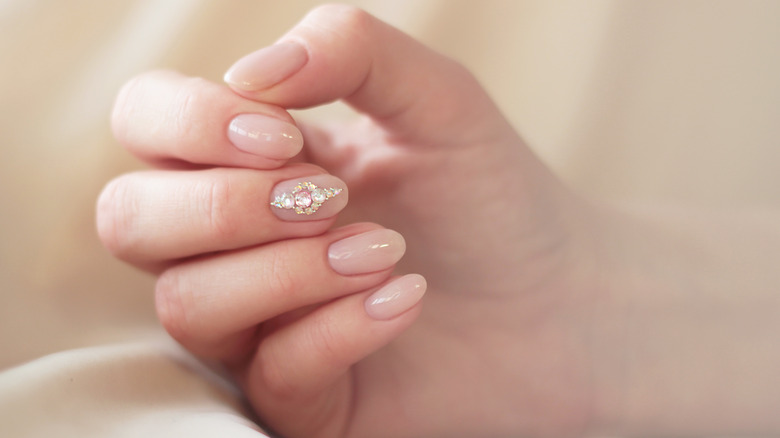sheer pink nails with rhinestones