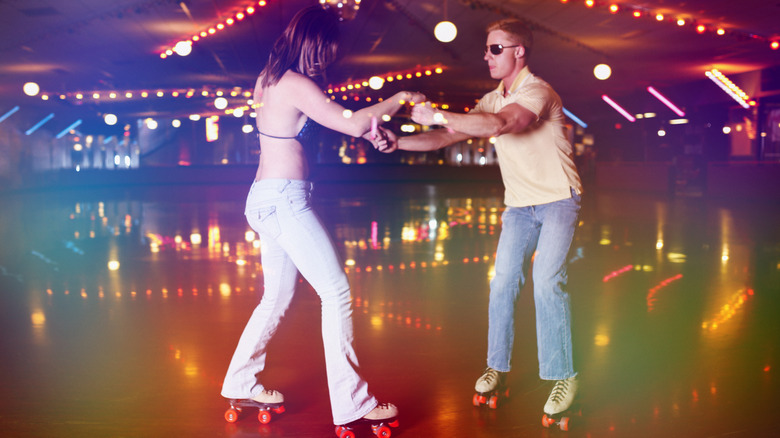 Couple rollerskates in roller disco