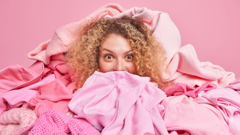 woman in pile of pink clothes