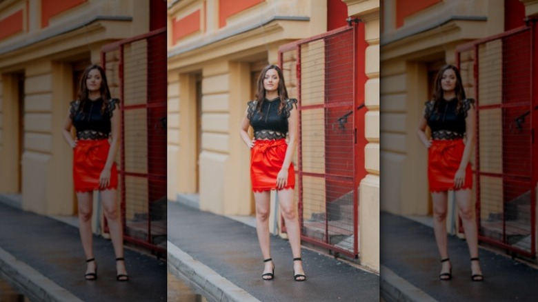 Woman wearing red leather skirt with a black blouse