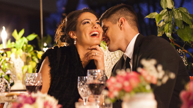 Couple laughing and having wine