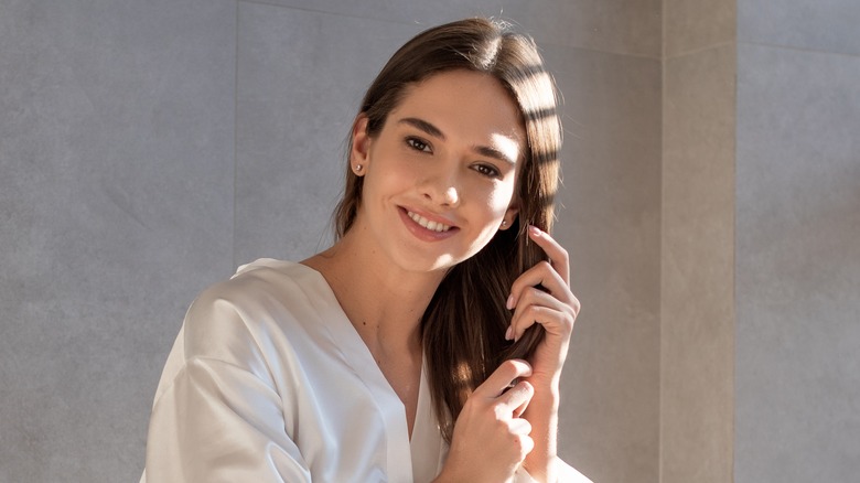 woman touching long brown hair