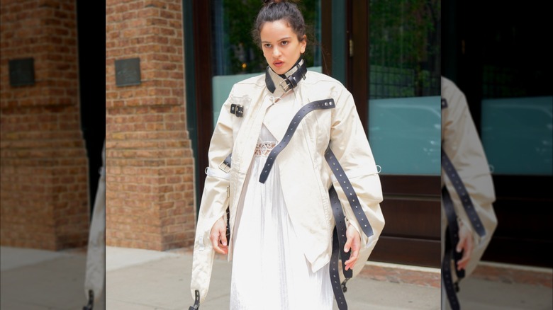 Rosalía wearing a white jacket