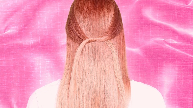 A woman showing off her rose gold hair