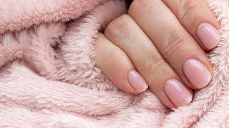 Pale pink nails on fuzzy blanket