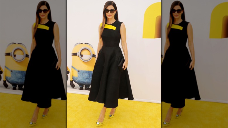 Sandra Bullock wearing Minions high heels and a black dress