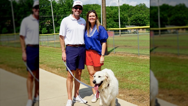 Sarah Huckabee Sanders with her husband and dog near a park