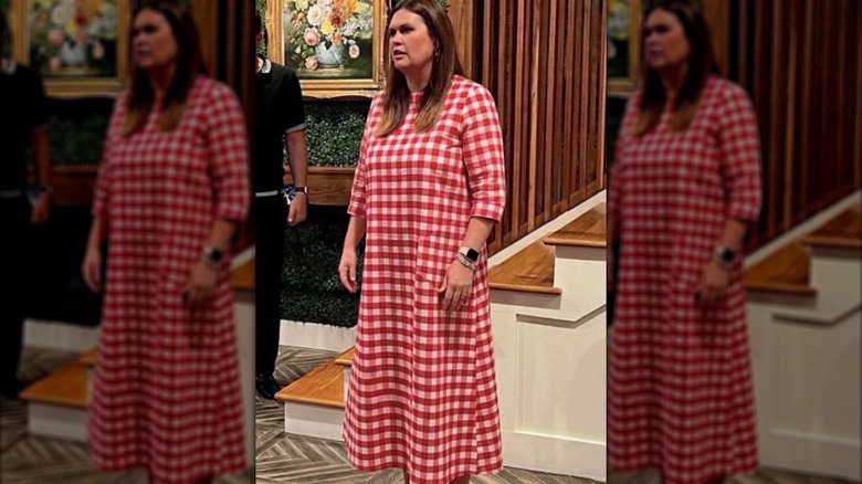 Sarah Huckabee Sanders in a red and white gingham maxi dress