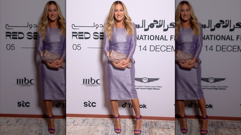 Sarah Jessica Parker posing at an event wearing a long sleeve lilac-colored dress in 2024.