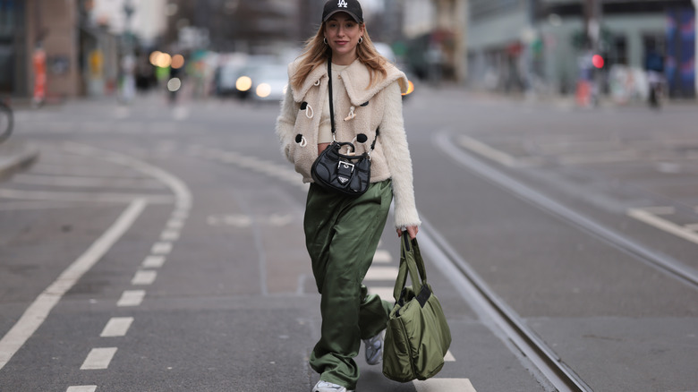 A woman wearing satin pants