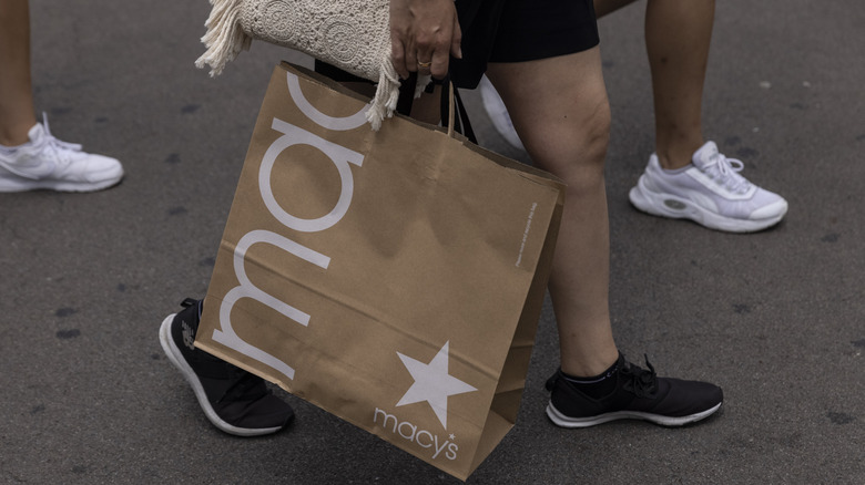 Shopper walking with Macy's bag