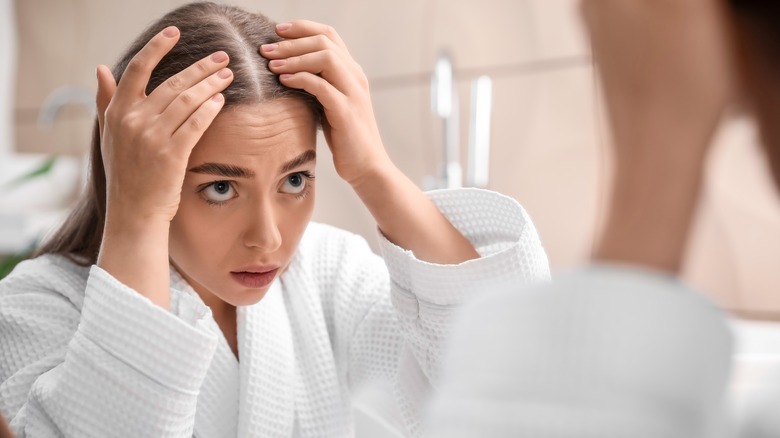 concerned woman with hair loss